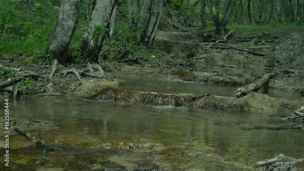 Small mountain river with rapids flowing in stony riverbed. Crimea mountains in spring. 4K UHD Small mountain river with rapids flowing in stony riverbed. Crimea mountains in spring. 4K UHD