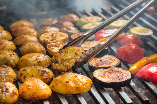 vegetables roast on a large grill