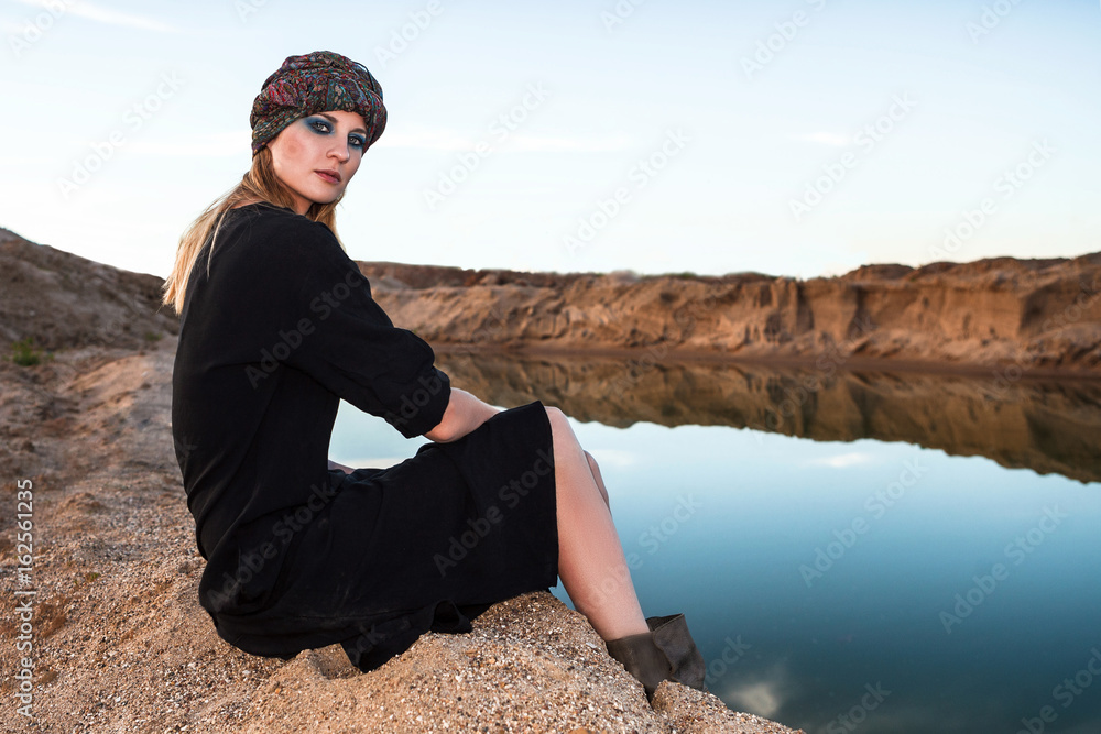 female sitting on shore in desert.. female sitting on shore in desert..