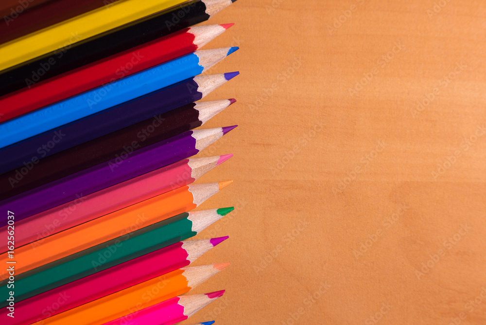 Color pencils on wood background close up Color pencils on wood background close up