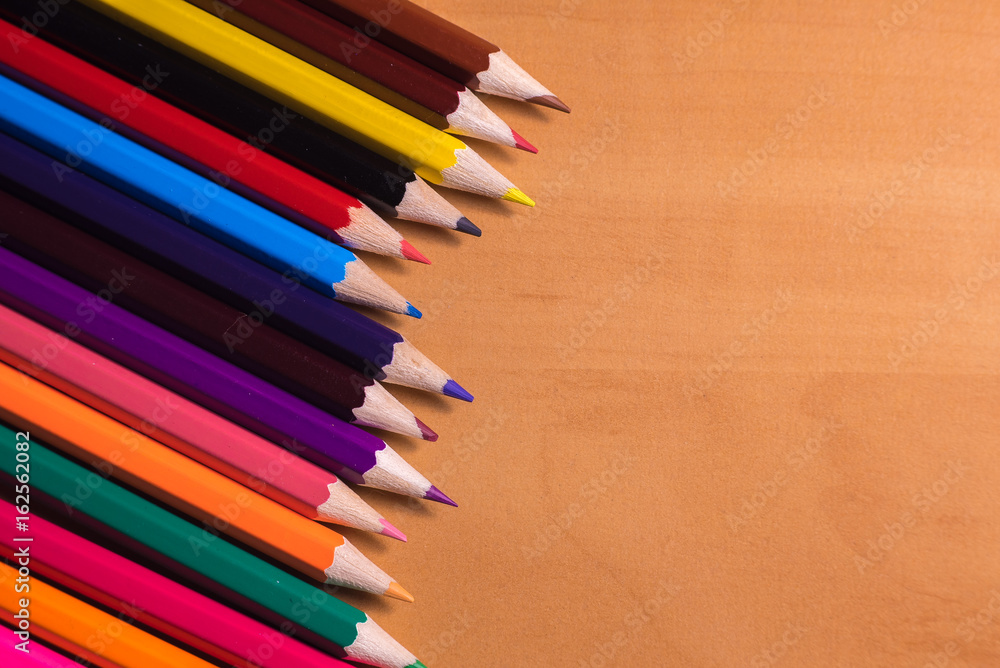 Color pencils on wood background close up Color pencils on wood background close up
