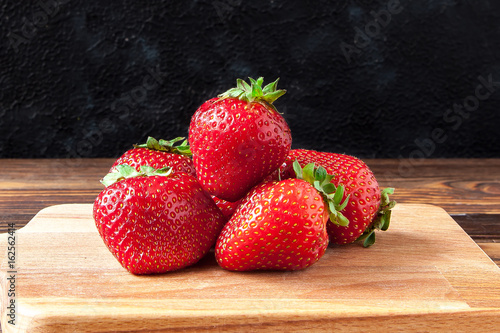 Fresh strawberries  on a black background photo