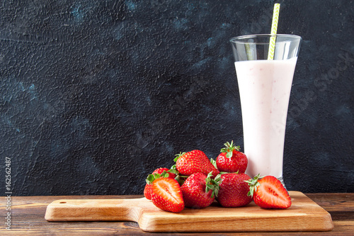 Fresh strawberries in a white deep plate on a black background photo