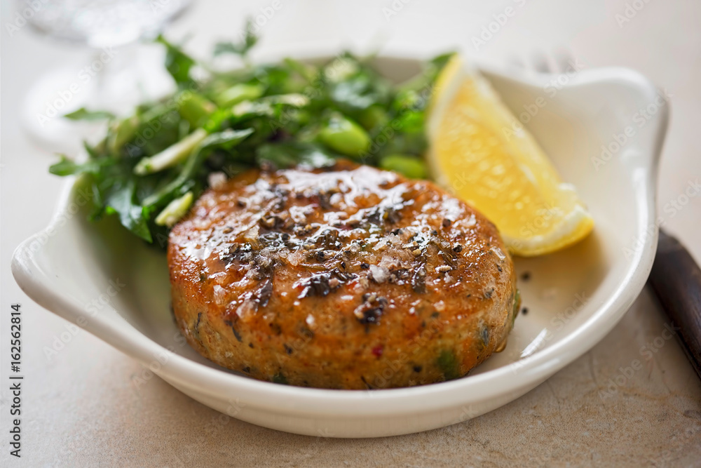 Thai style fishcakes with spicy soy glaze, green salad and lemon wedge 