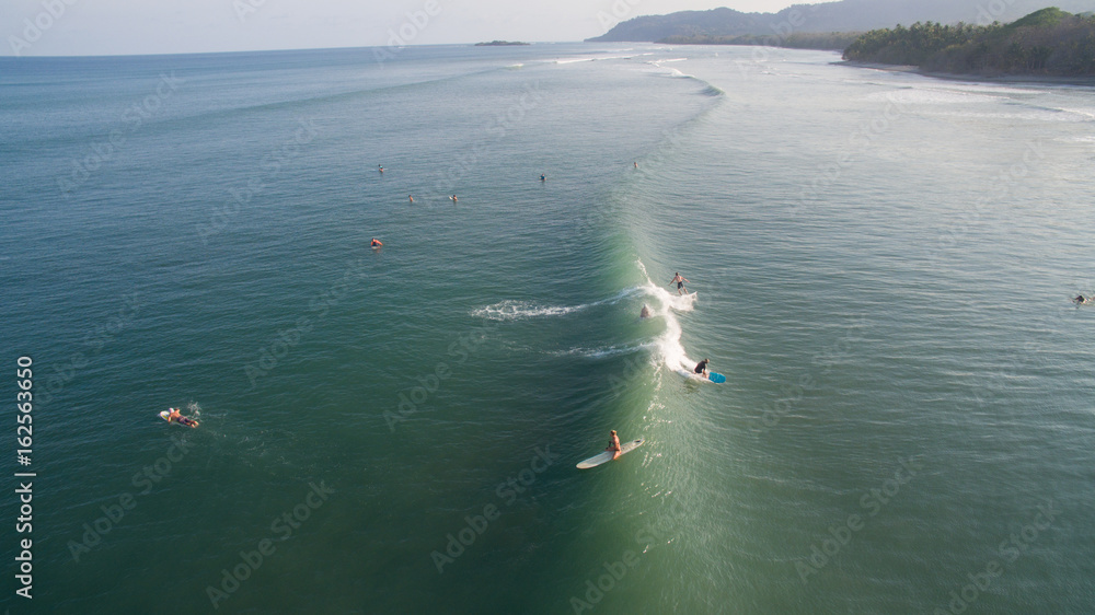 Aerial view of a surfer on a wave in Jaco, Costa Rica