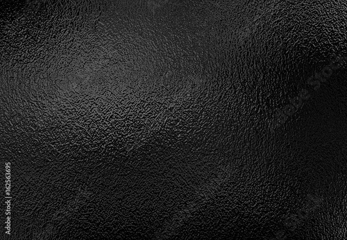 Background texture of shiny black metal foil photo