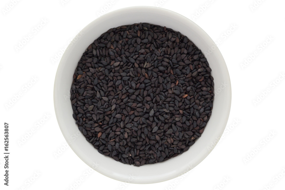 Black sesame seeds in white bowl, isolated on white background Black sesame seeds in white bowl, isolated on white background
