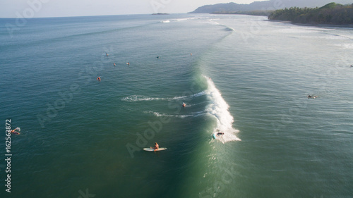 Aerial view of a surfer on a wave in Jaco, Costa Rica
