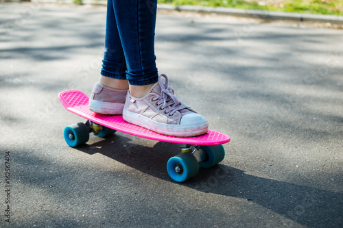 Teenage girl practicing short skateboard riding in park