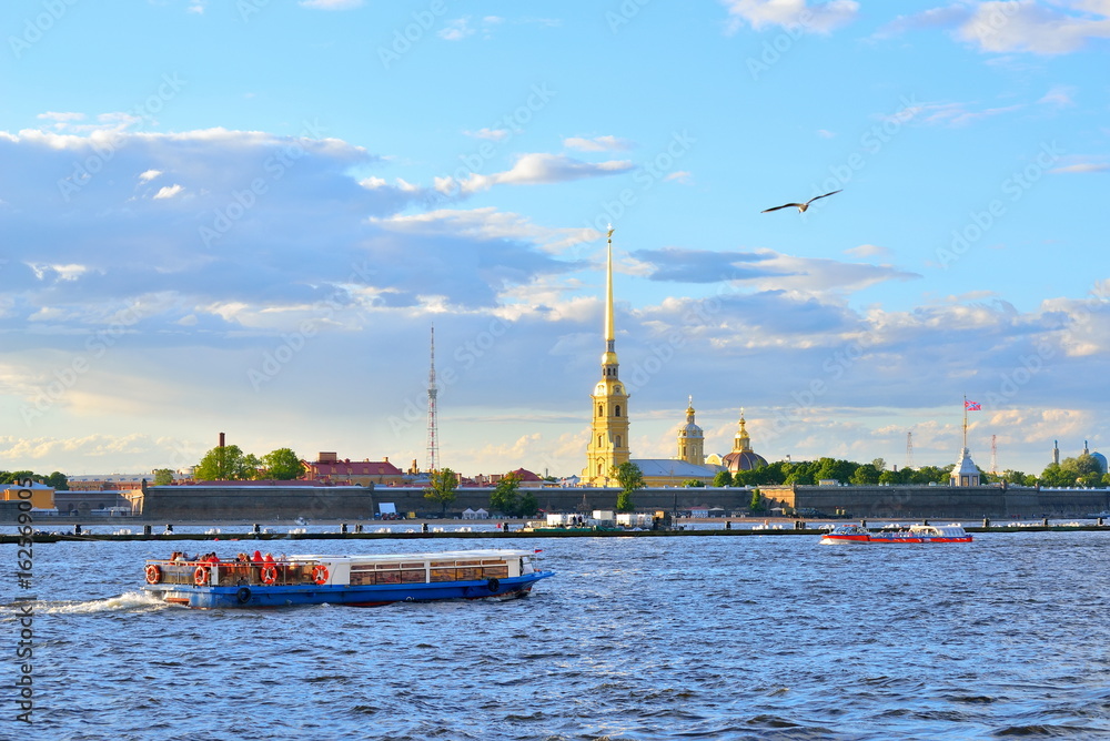 Tourist boats on the Neva river on the background of the fortres
