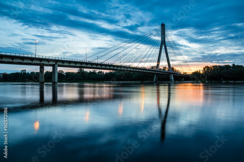 Fototapeta Naklejka Na Ścianę i Meble -  Sunrise on the Swietokrzyski bridge over the Vistula river in Warsaw, Poland