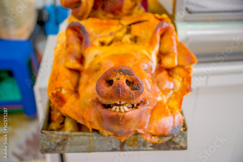 Delicious hornado roasted pork, over a silver tray, ecuadorian traditional typical andean food located in the municipal market in San Francisco in the city of Quito