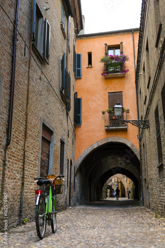 Bicycle parked near the wall of an ancient house in an Old Town of Ferrara  Italy