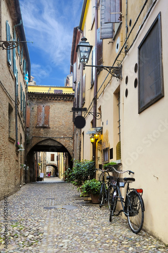 Bicycle parked near the wall of an ancient house in an Old Town of Ferrara  Italy