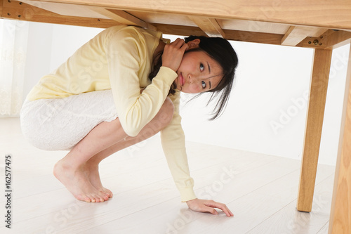 Young woman saving from an earthquake