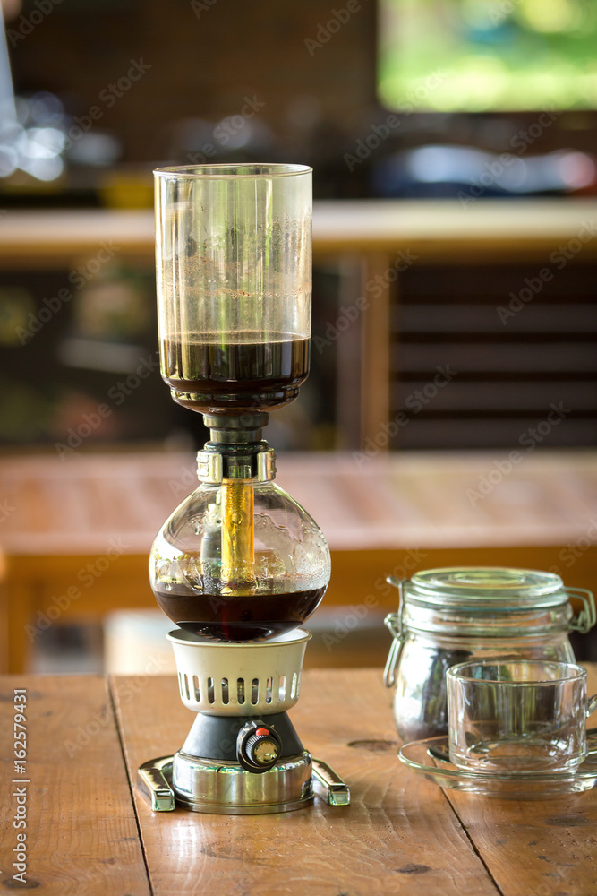 close up of siphon vacuum, coffee cup and siphon vacuum coffee maker at shop