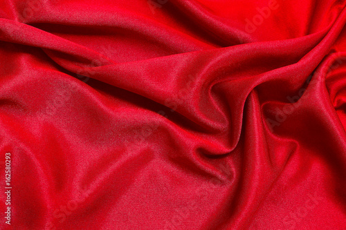 Red fabric pattern texture background, abstract background luxury cloth or liquid waves of grunge silk.