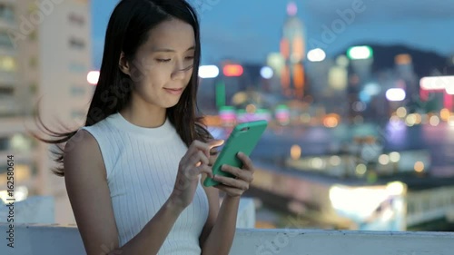 Wallpaper Mural Woman use of cellphone in the city of Hong Kong at night Torontodigital.ca
