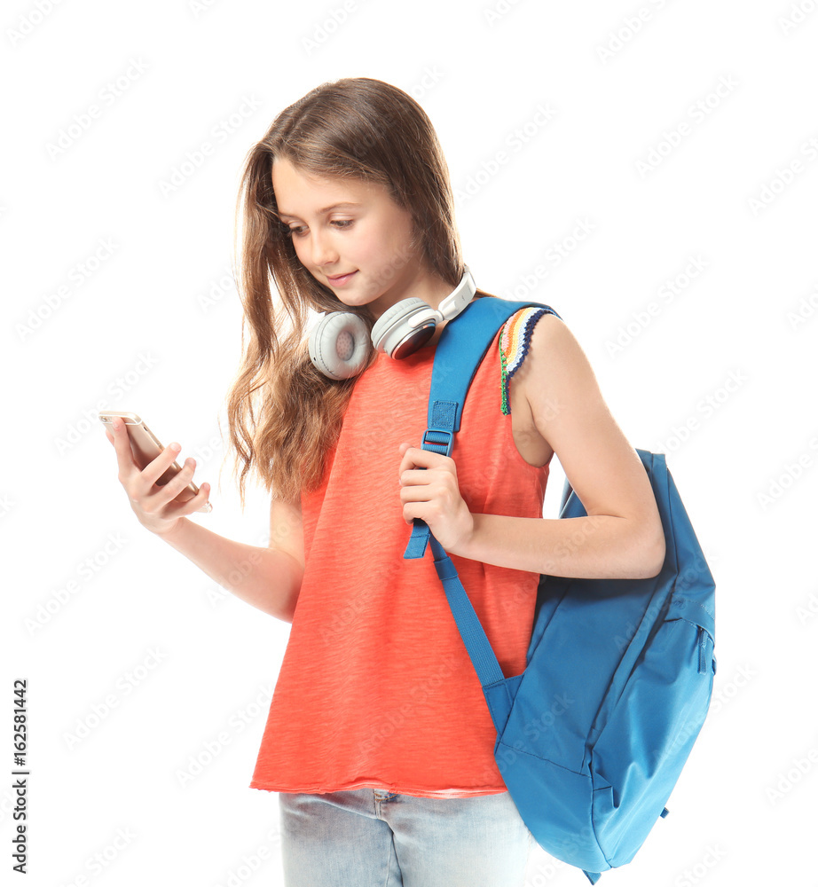Cute teenager girl with mobile phone, headphones and schoolbag on white background Cute teenager girl with mobile phone, headphones and schoolbag on white background