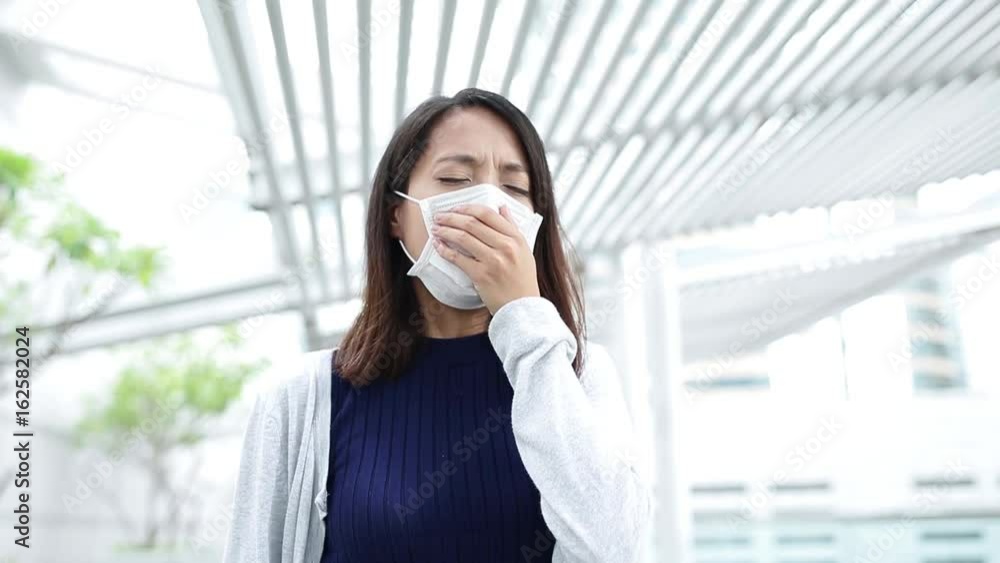 Woman wearing face mask and coughing at outdoor Woman wearing face mask and coughing at outdoor