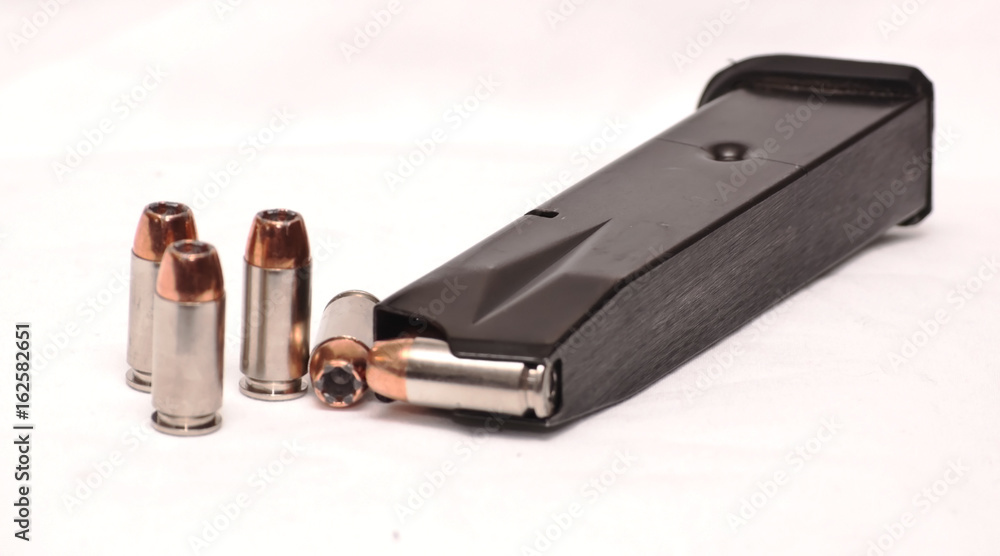 A semi loaded pistol magazine with several bullets not loaded A semi loaded pistol magazine with several bullets not loaded