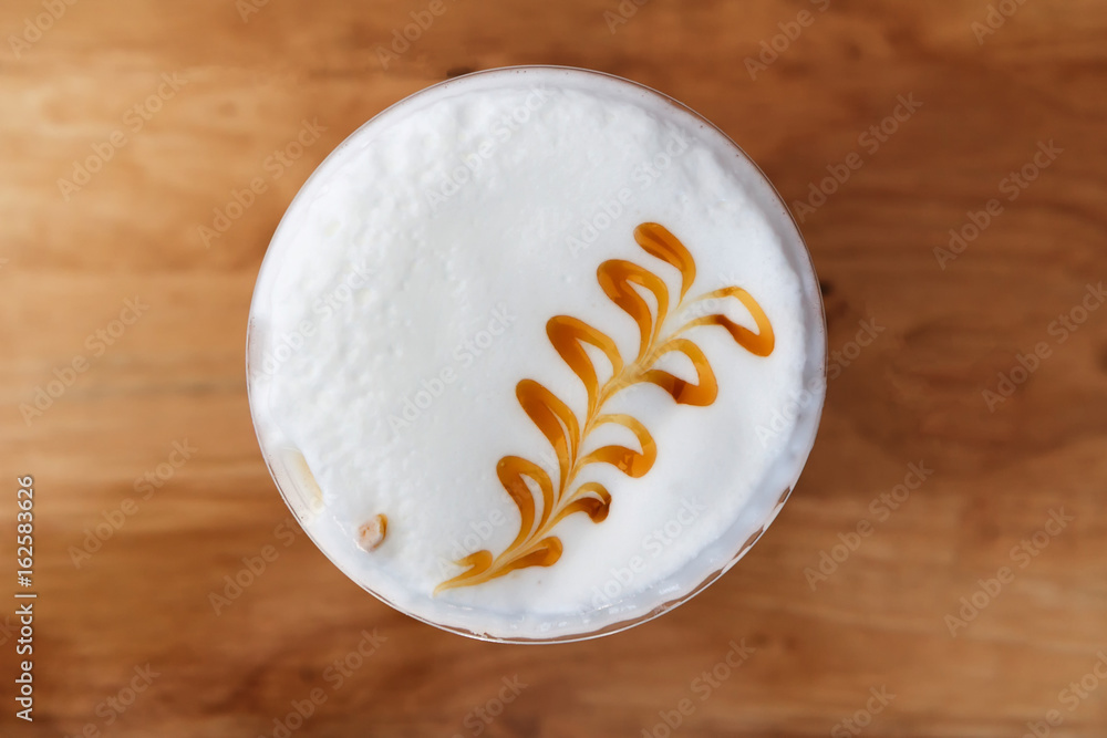 Top view of ice coffee with cocoa on a wooden table. Drinking coffee can help refresh, alert, reduce stress and work more and more. Top view of ice coffee with cocoa on a wooden table. Drinking coffee can help refresh, alert, reduce stress and work more and more.