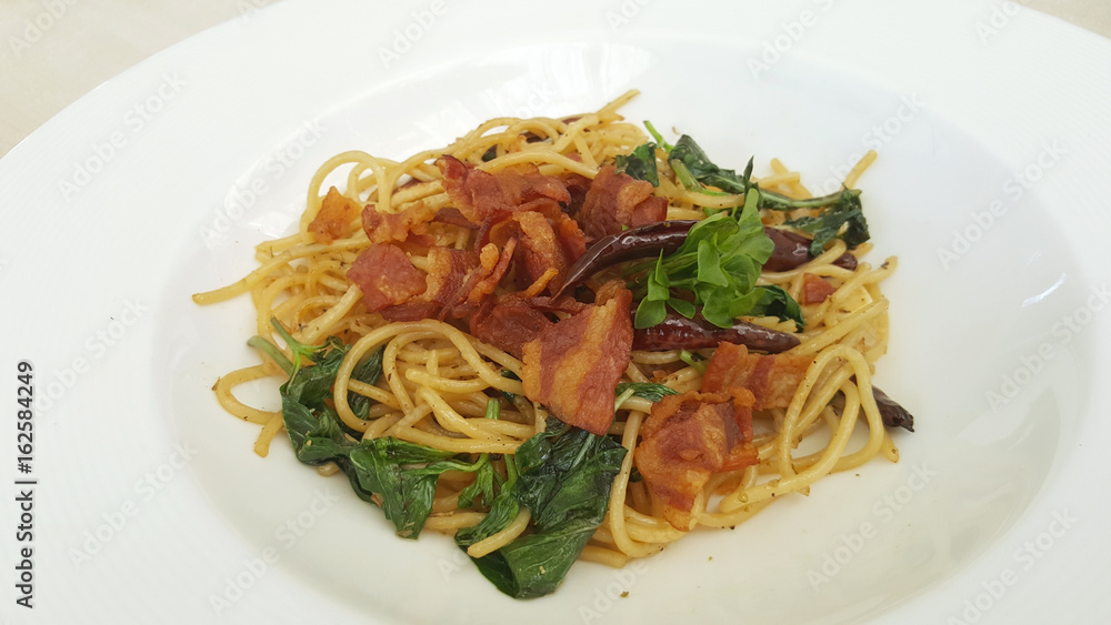 Bacon spaghetti on white plate