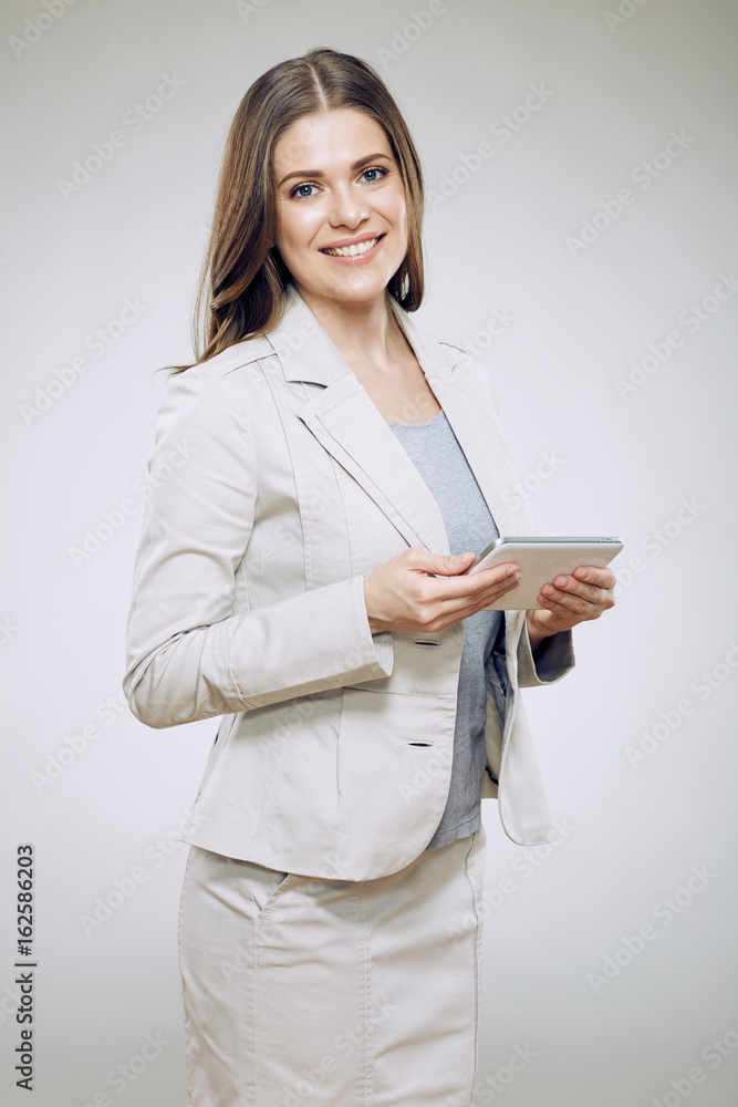 Smiling business woman suit dressed holding tablet. Smiling business woman suit dressed holding tablet.