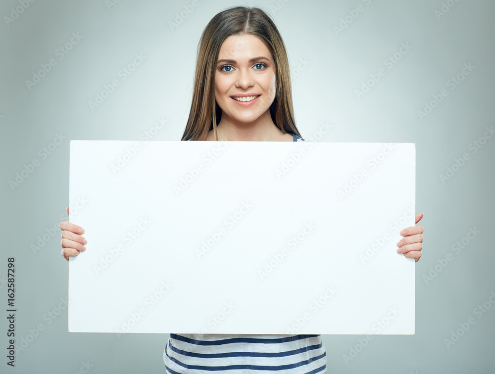 Smiling woman holding white banner wearin striped. Smiling woman holding white banner wearin striped.