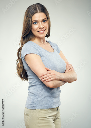 Smiling woman standing against gray