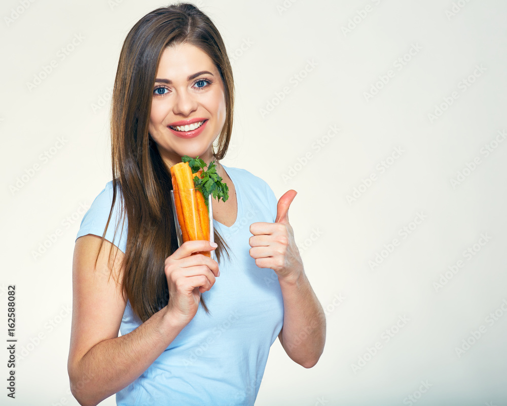Smiling woman holding carrot showing thumb up Smiling woman holding carrot showing thumb up
