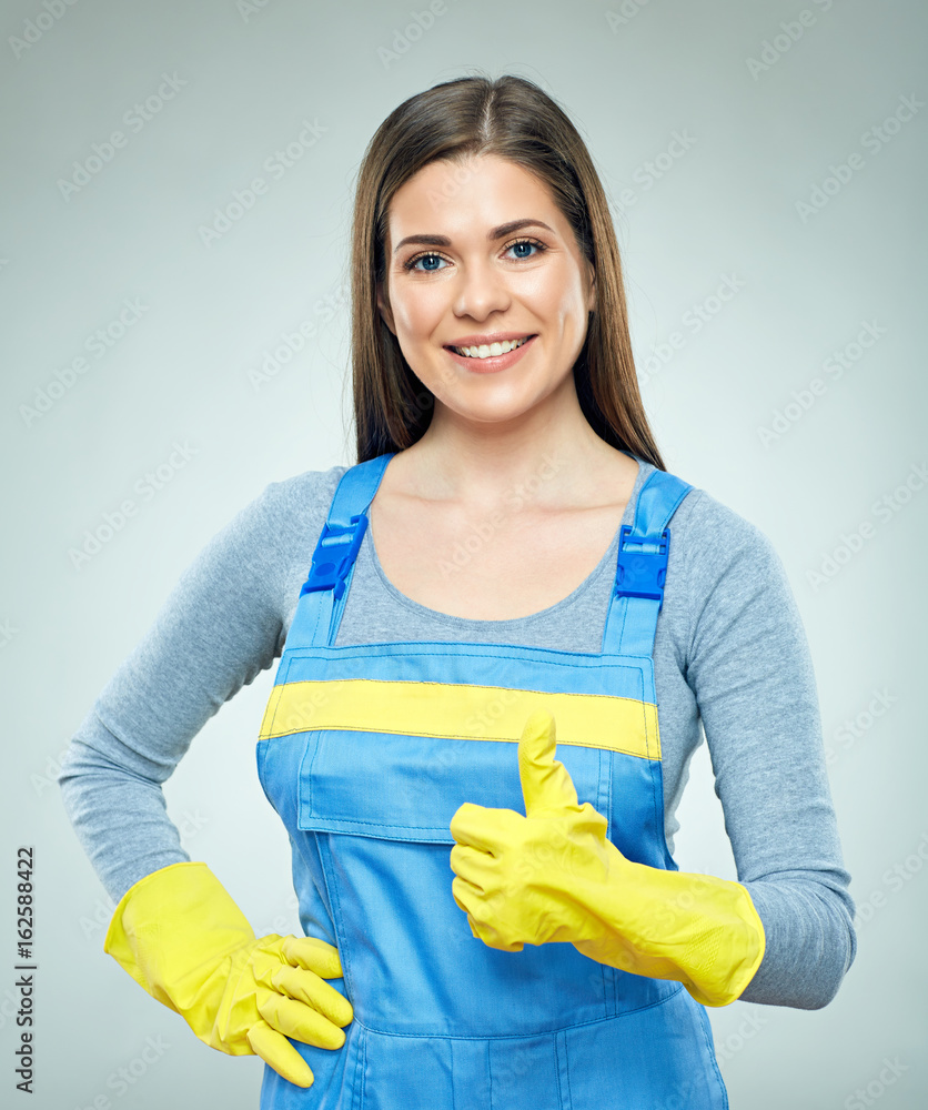 Smiling woman wearing builder uniform shows thumb up. Smiling woman wearing builder uniform shows thumb up.