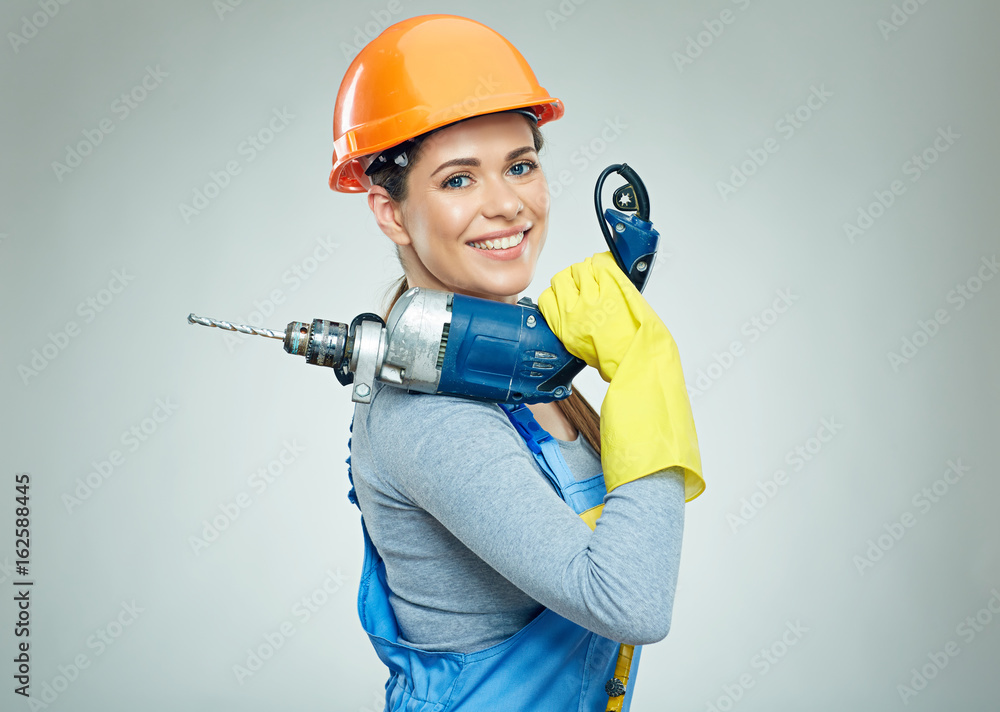 Woman builder holding drill tool. Woman builder holding drill tool.