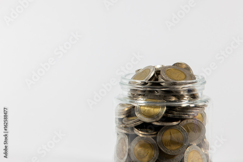 coins in glass bottle, money saving concept