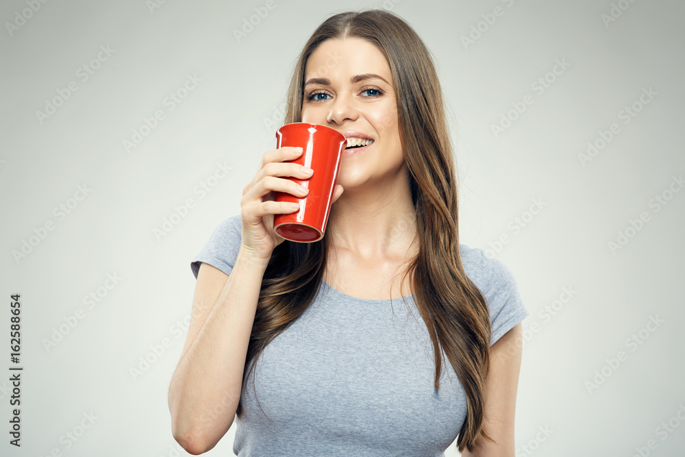 Smiling girl holding big red coffee glass. Smiling girl holding big red coffee glass.