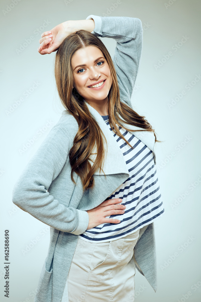 Smiling woman casual dressed posing on gray background. Smiling woman casual dressed posing on gray background.
