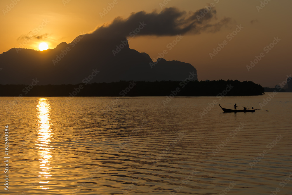 Silhouette Lifestyle Fisherman On Boat Fishing in Morning Golden Light.