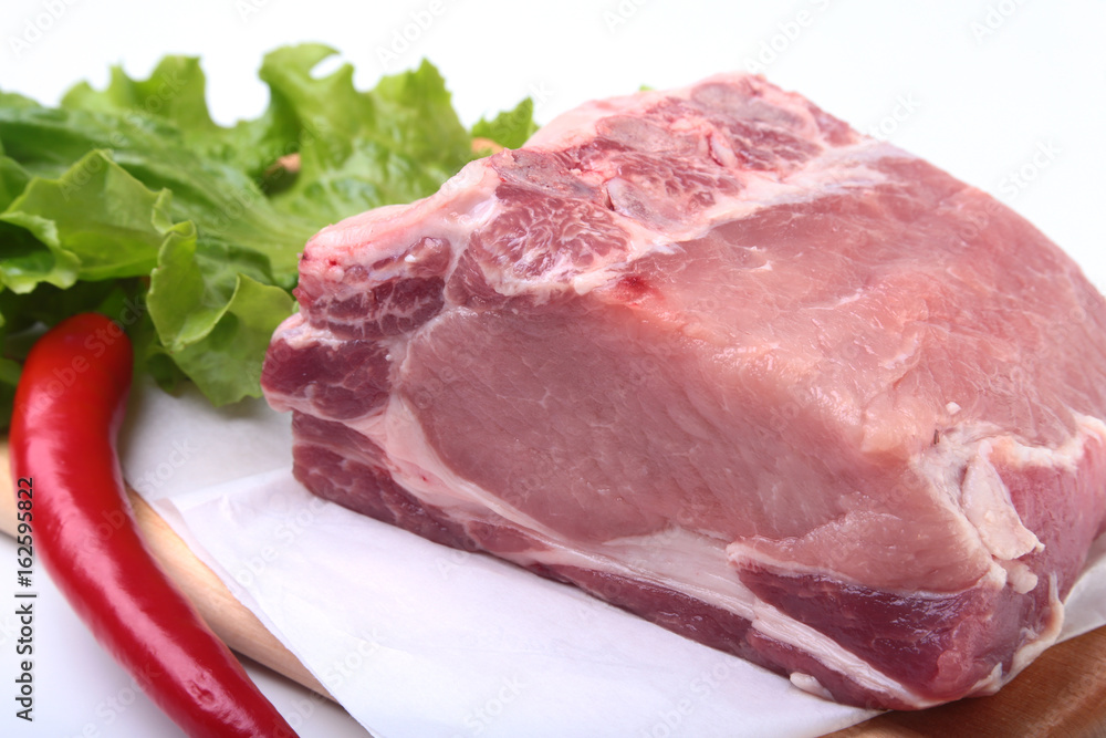 Raw pork chops with herbs and spices on cutting board. Ready for cooking.