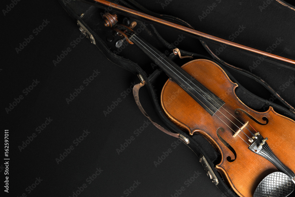 Old violin on a black background