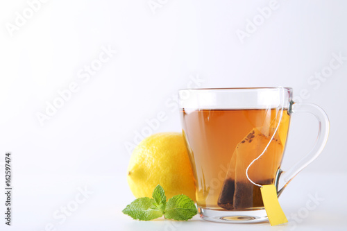 Cup of tea with teabag on a white background photo