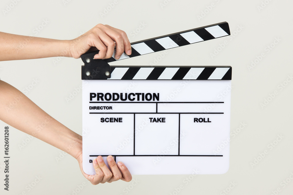 Close-up Of Hand Holding Clapperboard On White Background