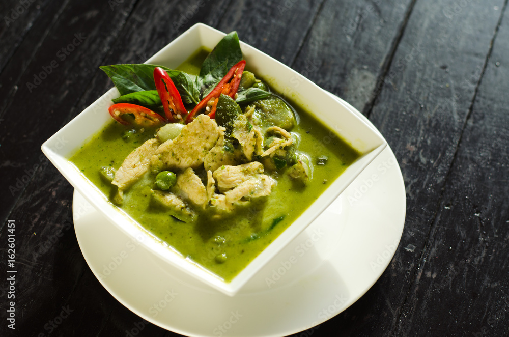 Thai Food: Green curry in white bowl on wood table Thai Food: Green curry in white bowl on wood table