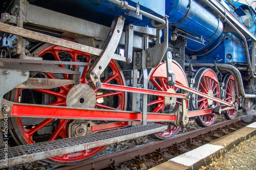 Red steam locomotive wheels.