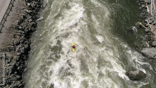 Aerial of Kayaker Charging at White Water River Rapid and Catching Hangtime Air in 4K 60P photo