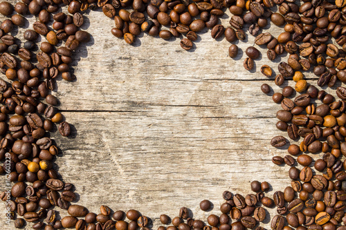 Coffee beans frame on grunge wooden background