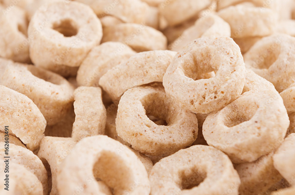 Beige rings corn flakes closeup background. Cereals texture.