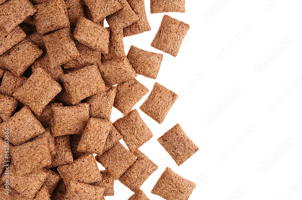 Decorative border of chocolate pads corn flakes isolated with copy space background. Cereals texture. Decorative border of chocolate pads corn flakes isolated with copy space background. Cereals texture.