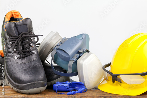 Safety equipment on wood background photo