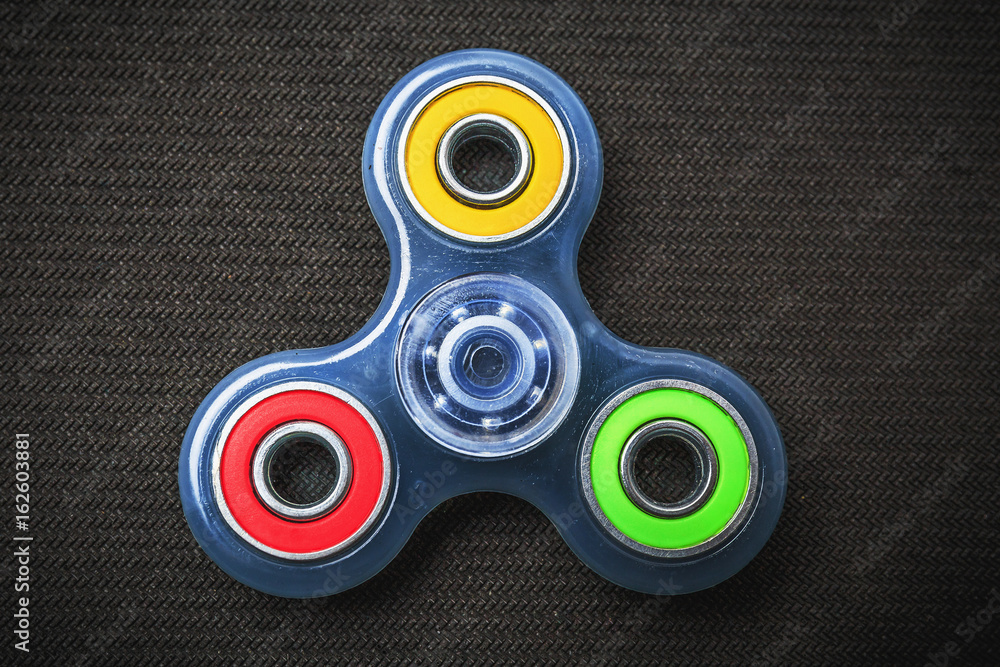 Blue transparent Fidget Spinner with colorful rings, stress relieving toy