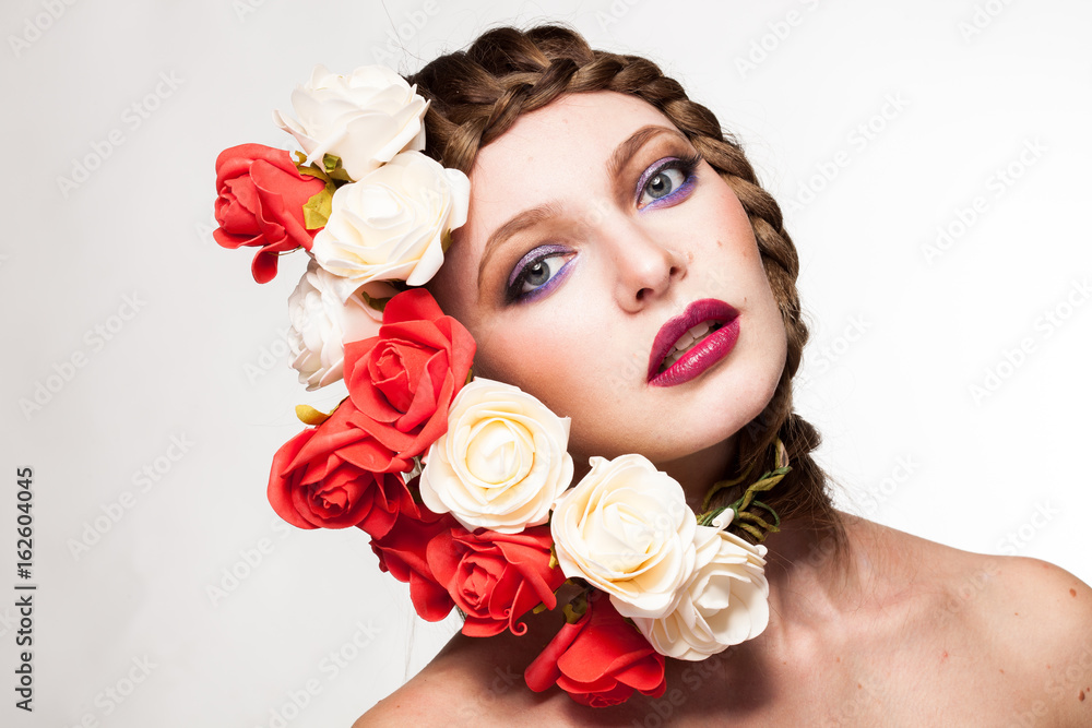 Naklejka premium Woman wearing flowers on her head in creative portrait in studio photo. Beauty and fashion. Glamour and summer